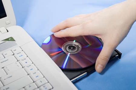 Put the DVD into the DVD-ROMの写真素材