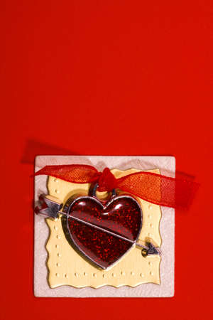 red metal heart with ribbon is glue on the design ribbonの写真素材