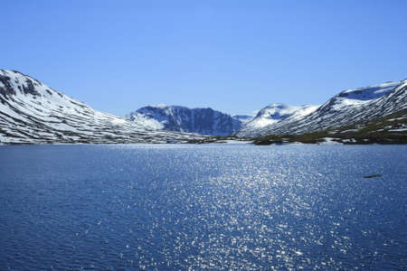 Blue lake and snow mountains in Norwayの写真素材