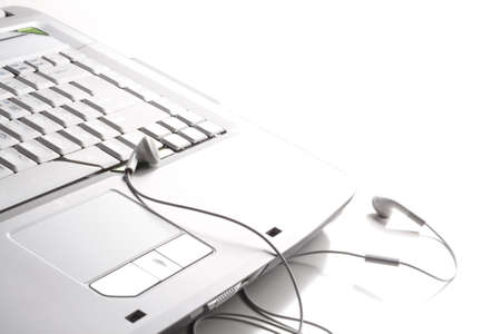 Headphones is on the white laptopの写真素材