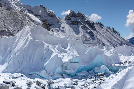Close up of Khumbu glacier from Everest Base Camp, Himalayas, Nepal. Beautiful turquoise glacier ice blocks lit by a bright sun light on a clear day. Stunning Himalayan glacier landscape.の写真素材