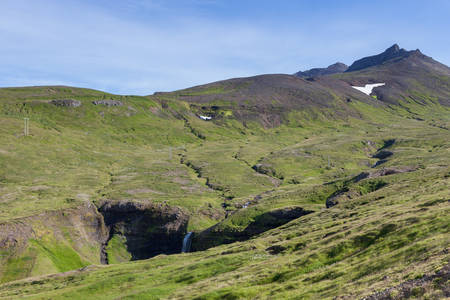 Icelandic landscape with green hills furrowed by numerous small rivers and waterfalls. Beautiful landscape in Saefellsnes peninsula in western Iceland.の写真素材