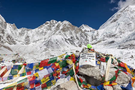 EVEREST BASE CAMP TREK/NEPAL - NOVEMBER 01, 2015: Everest Base Camp sign with stones and buddhist prayer flags and mountain Everest on the background. Everest Base Camp landmark.のeditorial素材