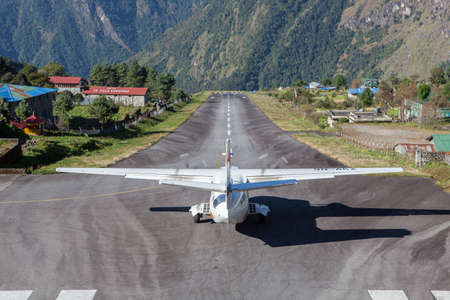 LUKLA/NEPAL - OCTOBER 18, 2015: Small airplane getting ready for take off from Tenzing-Hillary Airport in Lukla to Kathmandu.のeditorial素材