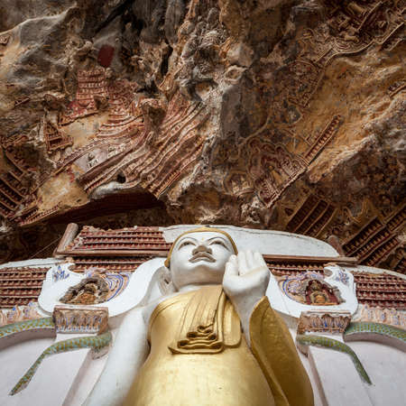 Buddha statue with carvings in Kaw Goon cave in Myanmar.の写真素材