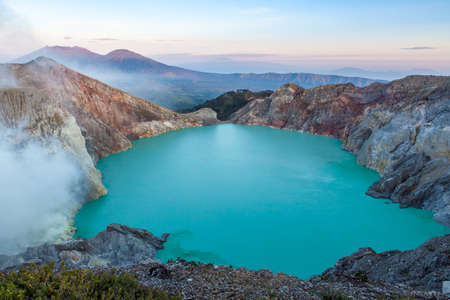 Colorful Ijen volcano crater lake and Raung volcano at the background.の写真素材