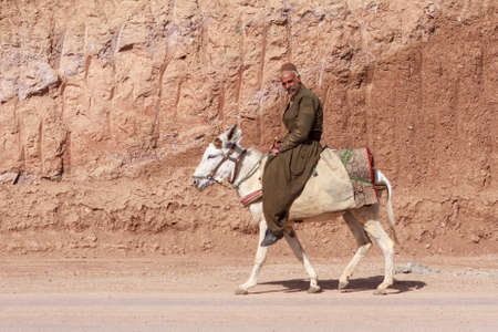 IRAN, KURDISTAN - MAY 19, 2012: Unidentified kurdish man riding donkey in Kurdistan.のeditorial素材