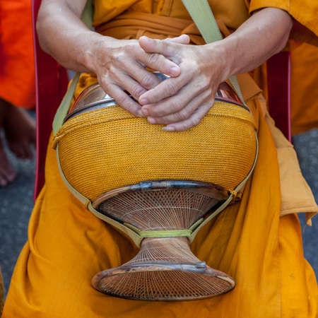 Thai buddhist monk's bowl in hands.の写真素材