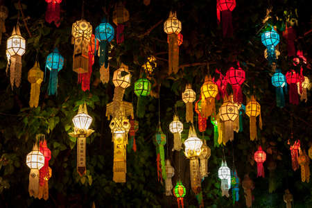 Colourful lantern light on sacred Bodhi tree during thai lantern festival. Beginning of Loy Krathong lantern festival. Colorful lanterns lights in Chiang Mai.の写真素材