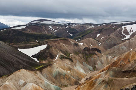Landmannalaugar National Park. Colorful slopes of the rhyolite mountains with snowy patchwork. Iceland adventure hiking Laugavegur trail to Landmannalaugar.の写真素材
