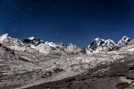Panoramic view over Gorak Shep village on a starry night. Beautiful night mountain landscape under bright moonlight. Stars above Himalayan mountain village, view from Kala Patthar mountain.の写真素材