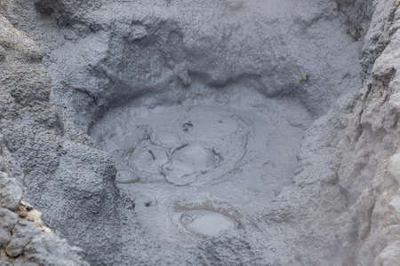 Mud bubbling in a hole at the geothermal active area of Hverir in Iceland. Fumarole field of...