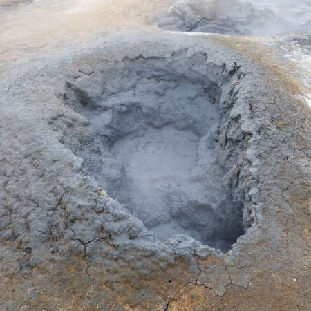 Grey mud bubbling in a hole at the geothermal active area of Hverir in Iceland. Fumarole field of Namafjall. Smelly sulfur grey mudpot.の写真素材