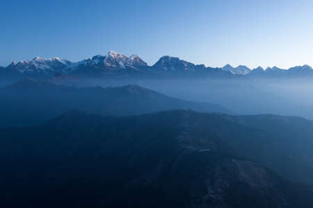 Mystic mountain early morning landscape in Himalayas, Nepal. Blue hour mystic mountains scenery with high altitude peaks and Everest mountain on the background.の写真素材