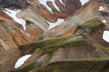 Landmannalaugar National Park. Colorful slopes of the mountains with snowy patchwork. Iceland adventure hiking Laugavegur trail to Landmannalaugar.の写真素材