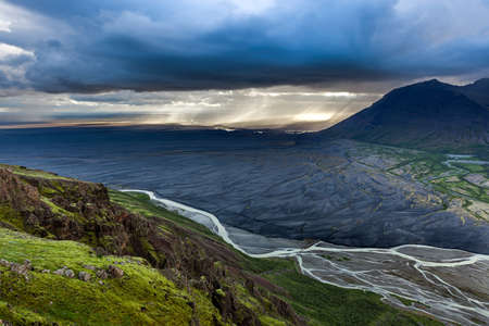 Breathtaking icelandic landscape. Skaftafell national park in Iceland. Green cliffs, streams and black lava fields.の写真素材