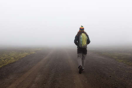 Snaefellsness, Iceland - Jul 21, 2016: Girl hiking alone in the fog in the middle of Icelandic rural...