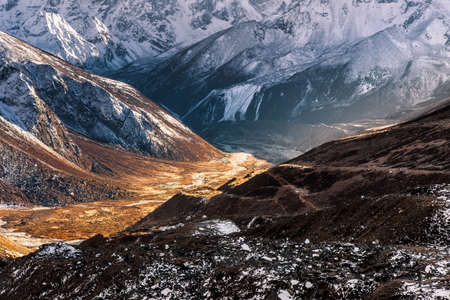 Abstract mountain background. Sunny valley among high snowy mountains on a bright sunny day. Himalayas mountains in Sagarmatha National Park, Nepal.. bold photo.の写真素材