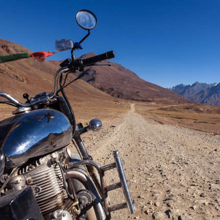 Moto travel in India. Beautiful road in Ladakh. View from motorcycle. Dirt road in mountains.の写真素材