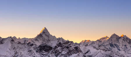 Pinkish sunrise above himalayan peaks. Cover sized photo. Beautiful high mountains landscape.の写真素材