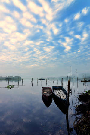 there are two fishing boats ready for fishing in the  morning at the dam の写真素材