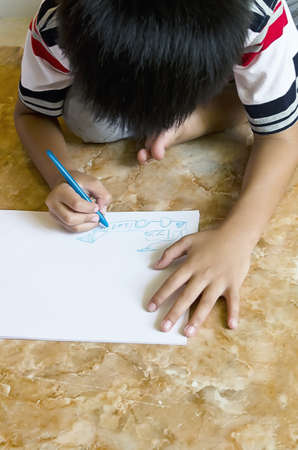 Children drawing sit on floor in the houseの写真素材