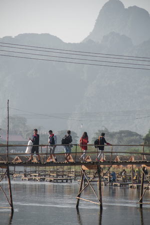 View of villagers crossing the wooden bridgeのeditorial素材