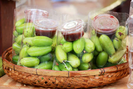 Garcinia fruit with spicy dipping sauce (fresh-food market in Thailand)の写真素材