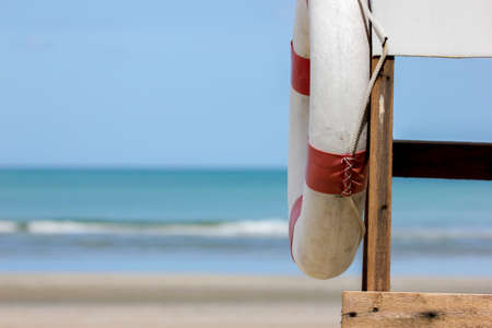 Red and  white life ring on life guard chair, lifebuoy, selective focusの写真素材