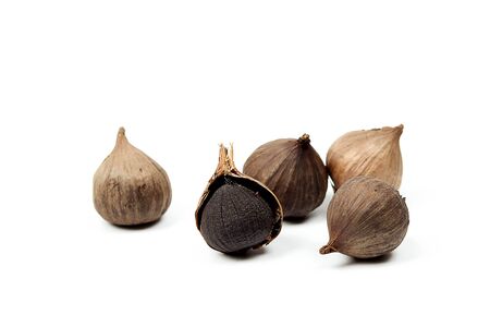 Black garlic isolated on white background.の写真素材