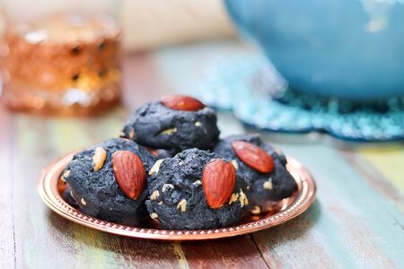 Charcoal cookie with almond for tea time.の写真素材