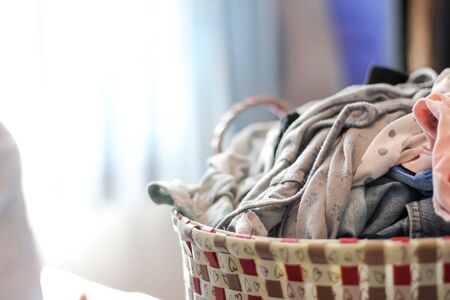 Dirty clothes in a laundry basketの写真素材