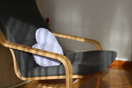 Comfortable wood chair with heart pillowの写真素材