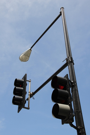  Two traffic light pole street lighting on the background of blue skyの写真素材