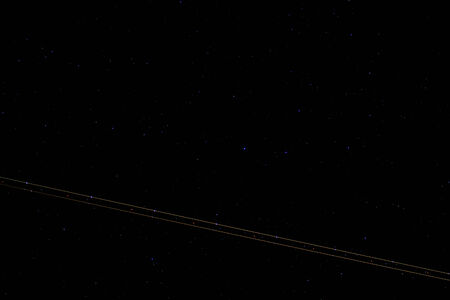 The starry sky is a trail from the sidelights of the aircraft, long shutter speed