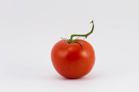 one fresh red tomato isolated on whiteの写真素材