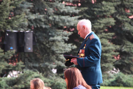 Moscow, Russia - May 9, 2012. People lay flowers at the Eternal flame in Aleksandrovsk to a garden...