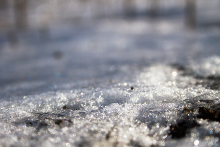Melting spring snow abstract natural light backgroundの写真素材