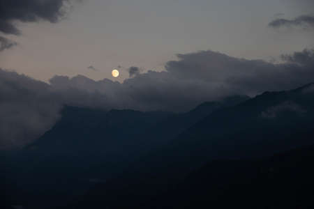 Moon mountains and night cloudsの写真素材
