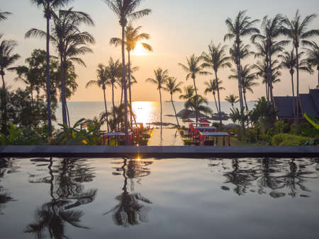 Koh Phangan, THAILAND - 15 March 2017 - Luxury resort sunset view to the sea with the palm trees and swimming pool. Concept of Thailand Vacations.のeditorial素材