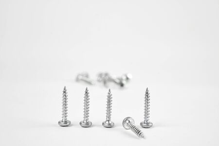 Several construction screws in the foregroundの写真素材