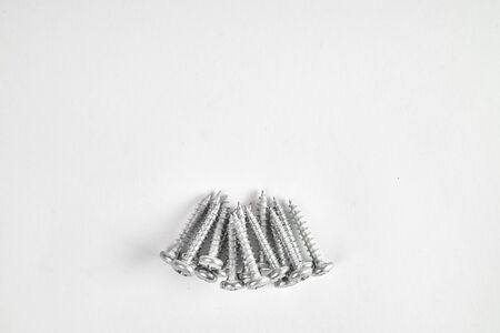 Multiple screws isolated on a white background.の写真素材