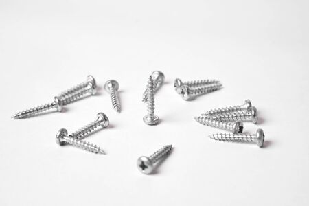 Construction screws on a white background. Several screws isolated on a white background.の写真素材