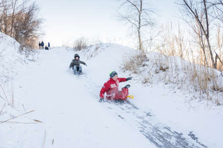 Volgograd. Russia - January 22, 2017. Children roll with snow slidesのeditorial素材