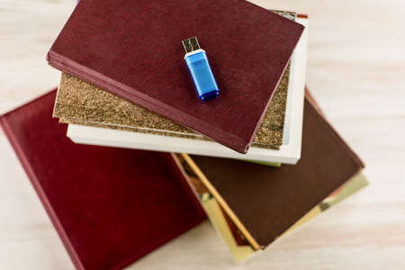 memorization of knowledge: books and organizer are on the table under the blue stick, symbolizing...