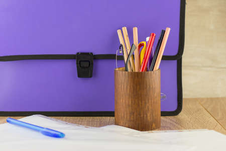 lilac closed documents folder is on the table, next to the pencil case with glasses and stationery, documents, penの写真素材
