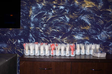 white and red napkins in stands on a table against a dark blue wallの写真素材