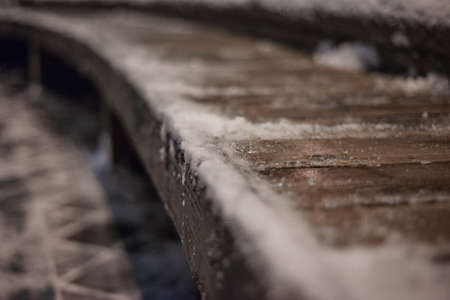 winter, the bench on the street froze and covered with snowの写真素材