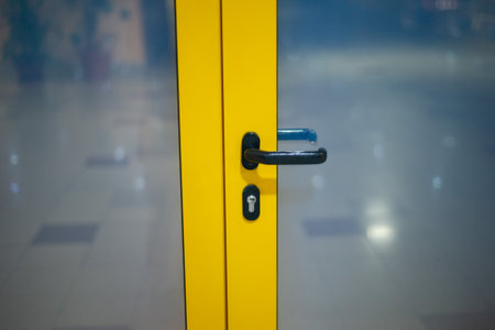 Yellow door with a handle in the buildingの写真素材