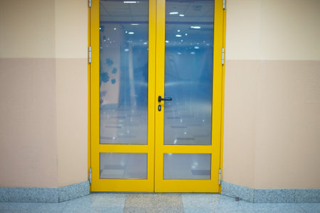 Yellow door with a handle in the buildingの写真素材